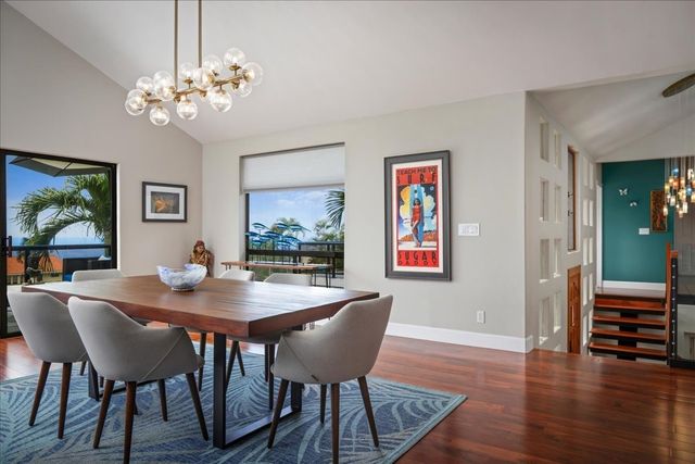 a view of a dining room with furniture wooden floor and a chandelier
