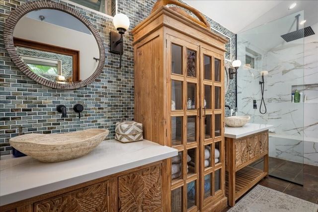 a bathroom with a sink a mirror and shower