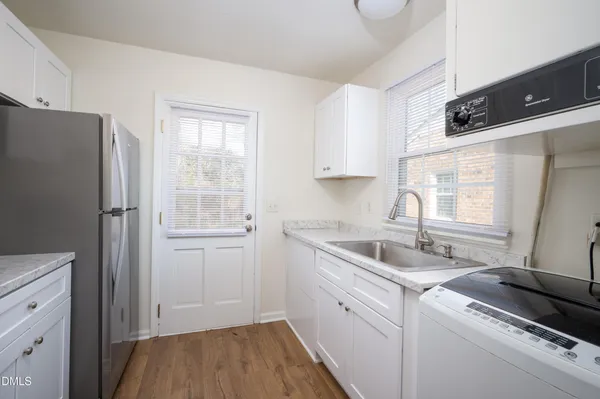 a kitchen with a sink cabinets and window