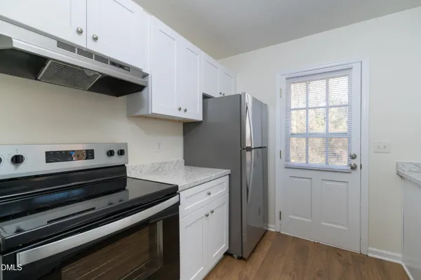 a kitchen with stainless steel appliances a refrigerator and a stove