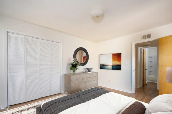 a bedroom with a bed and a dresser
