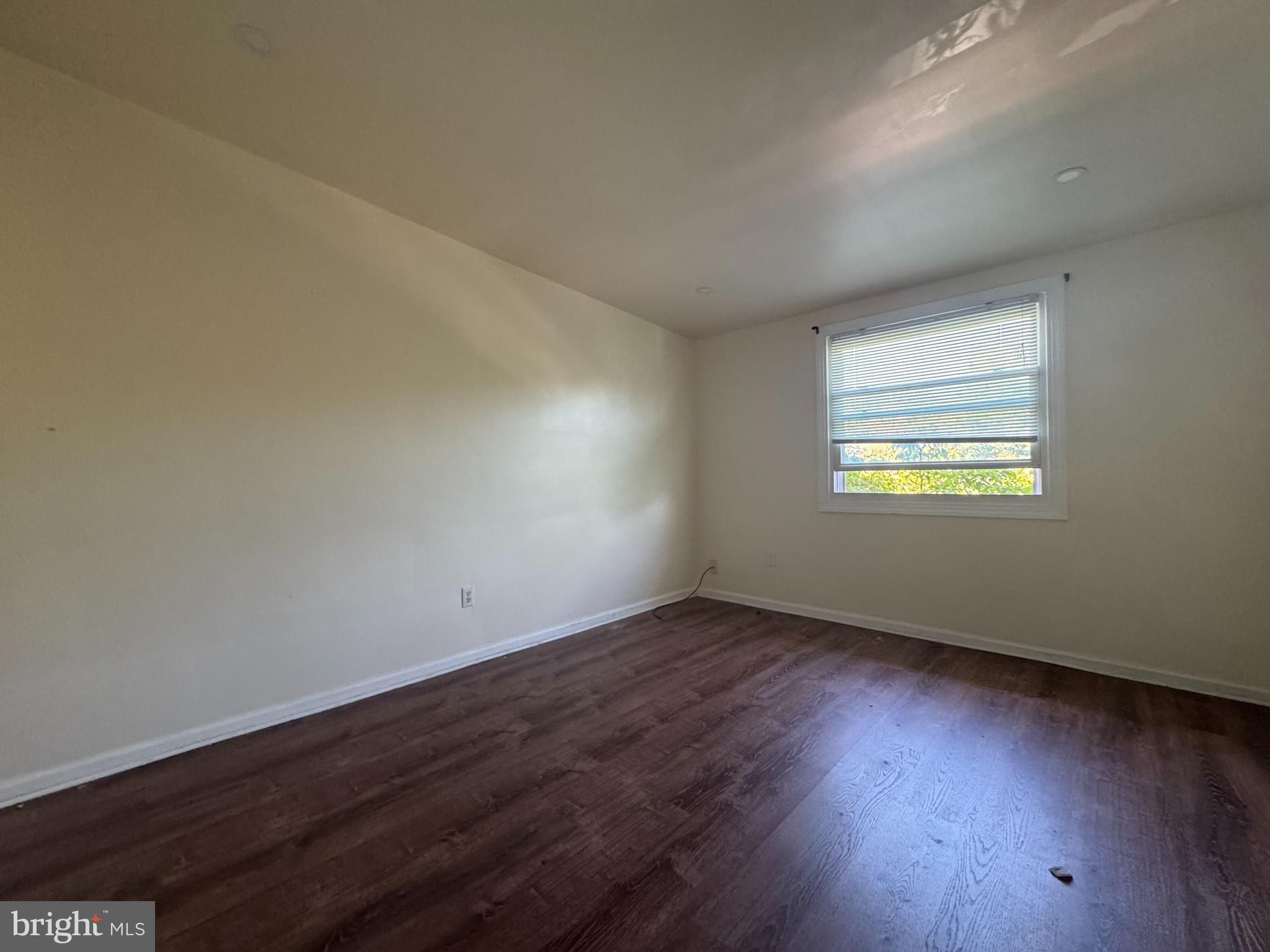 1015 Quebec Terrace Silver Spring, MD 20903 - Photo 11 of 13 a view of an empty room with wooden floor and a window