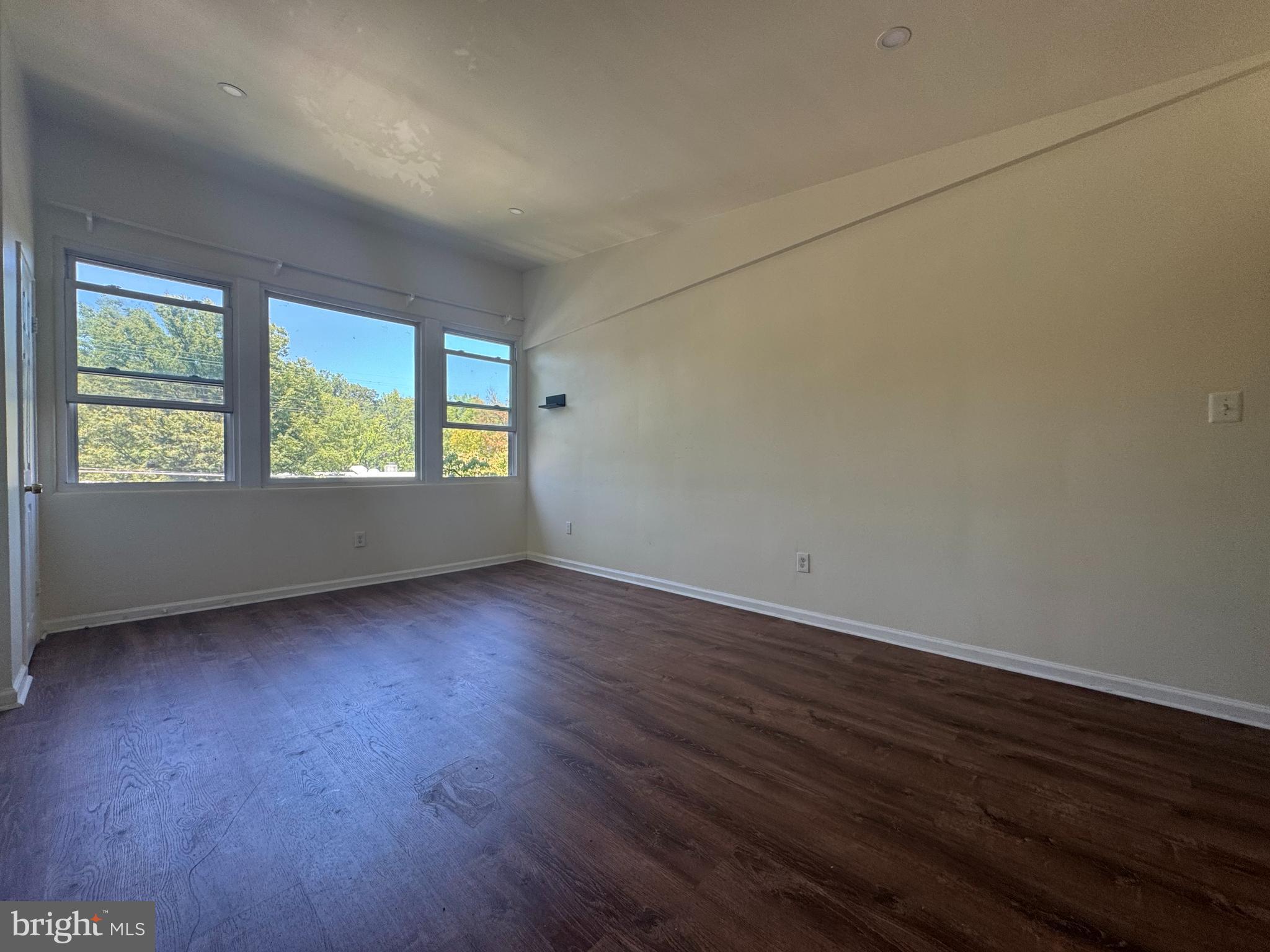 1015 Quebec Terrace Silver Spring, MD 20903 - Photo 6 of 13 an empty room with wooden floor and windows