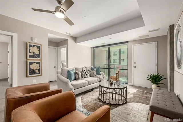 a living room with furniture potted plant and a window