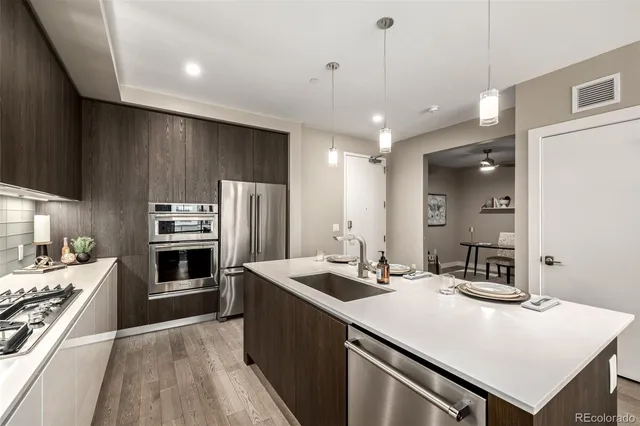 a kitchen with a stove a sink and a refrigerator