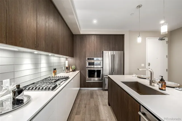 a kitchen with a sink stove and refrigerator