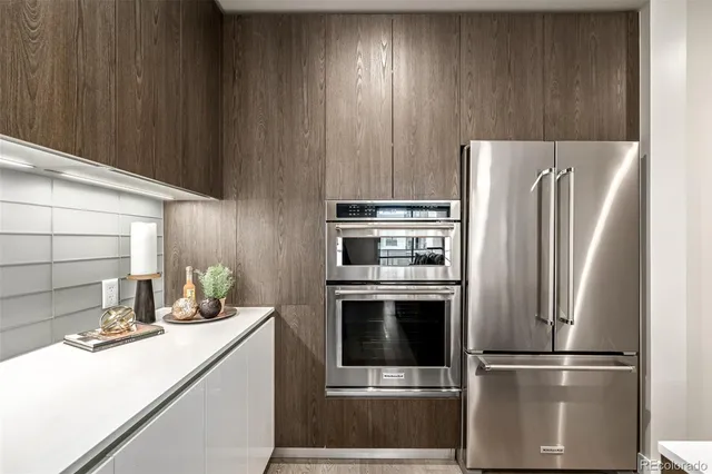 a kitchen with a refrigerator sink and cabinets