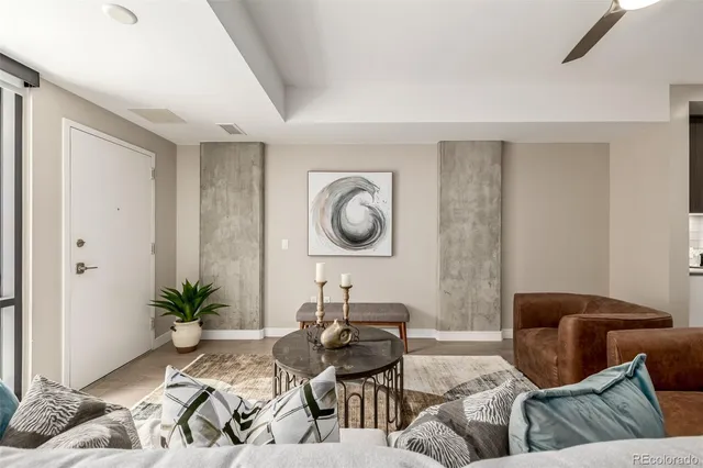 a living room with furniture and a potted plant