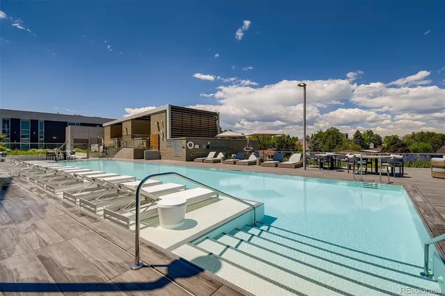 a view of a swimming pool with outdoor seating