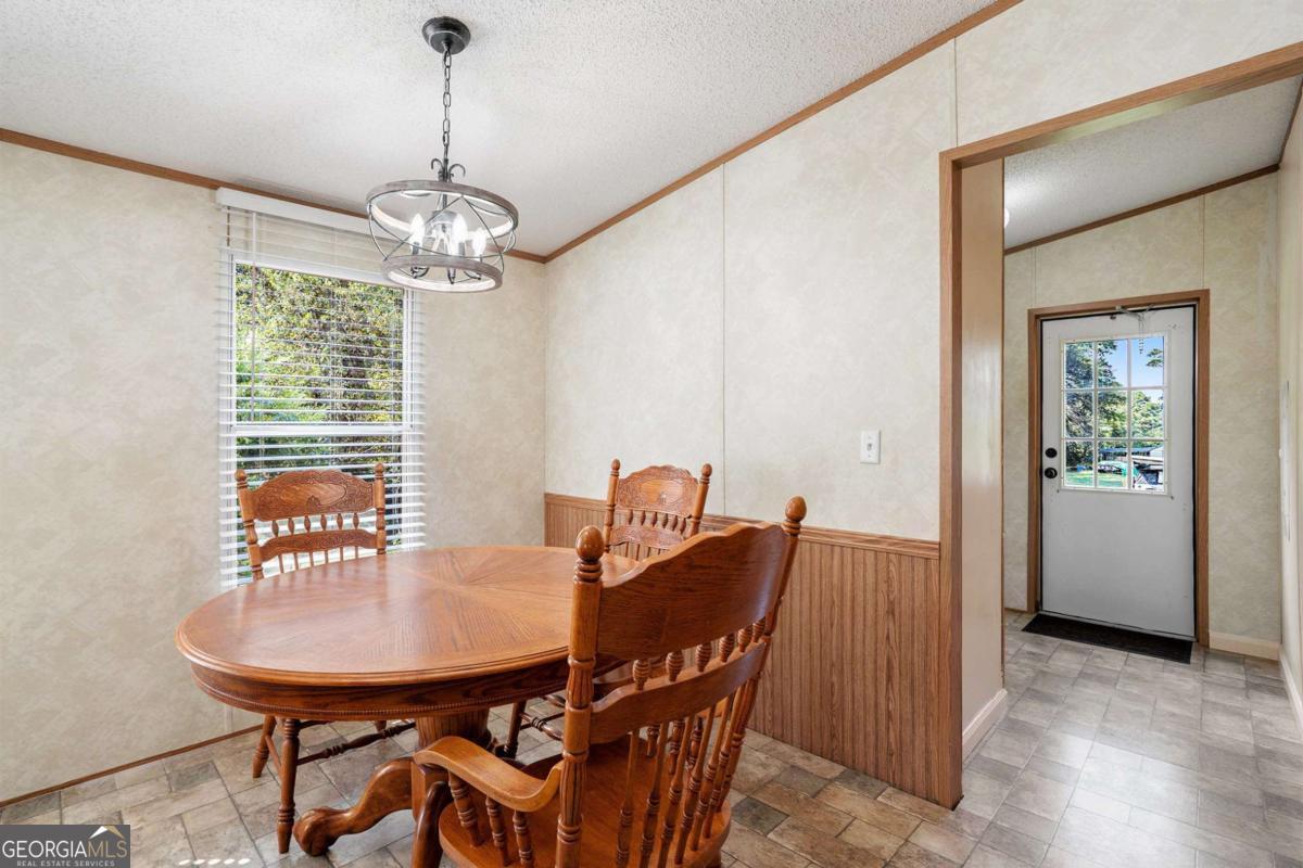 359 Norton Bridge Road Chatsworth, GA 30705 - Photo 14 of 28 a view of a dining room with furniture window and wooden floor
