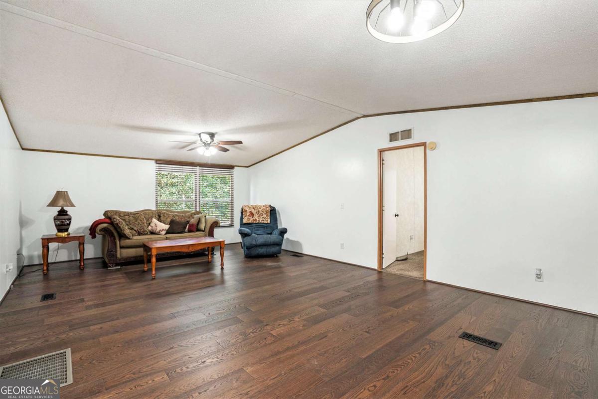 359 Norton Bridge Road Chatsworth, GA 30705 - Photo 22 of 28 a living room with furniture and a wooden floor