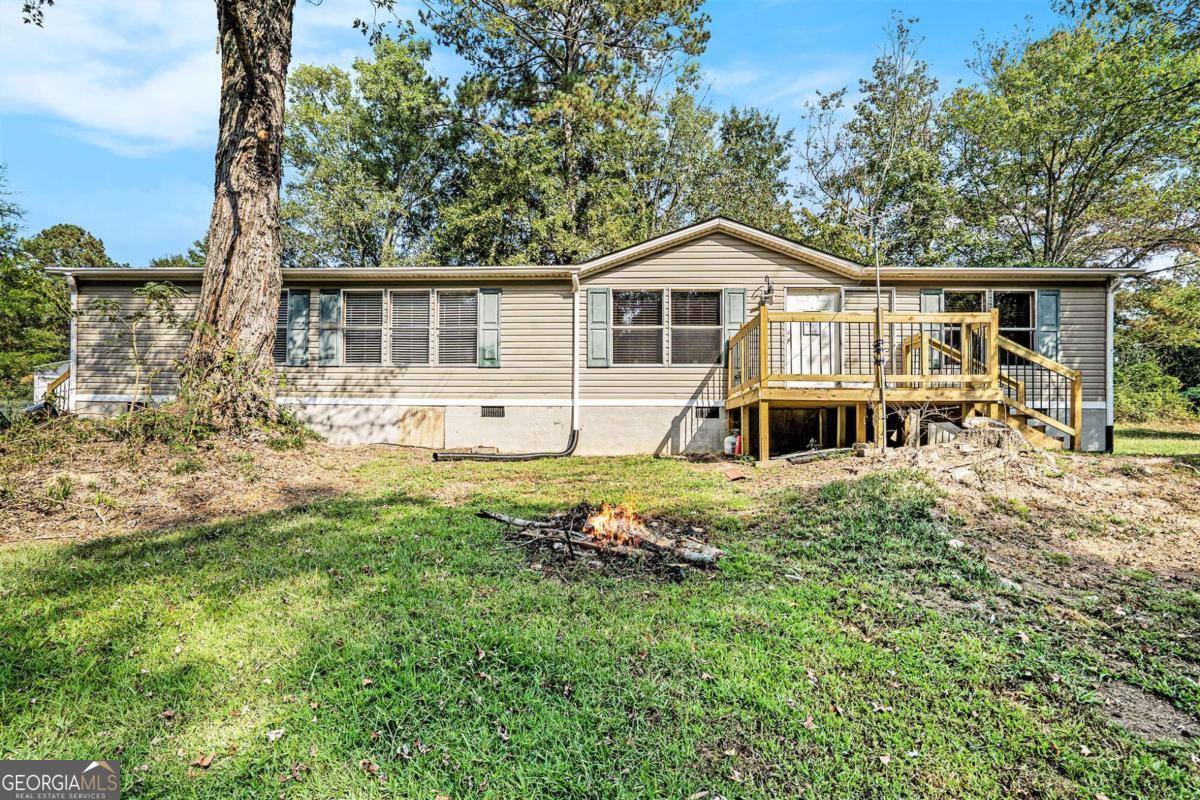 359 Norton Bridge Road Chatsworth, GA 30705 - Photo 3 of 28 a front view of a house with a yard table and chairs