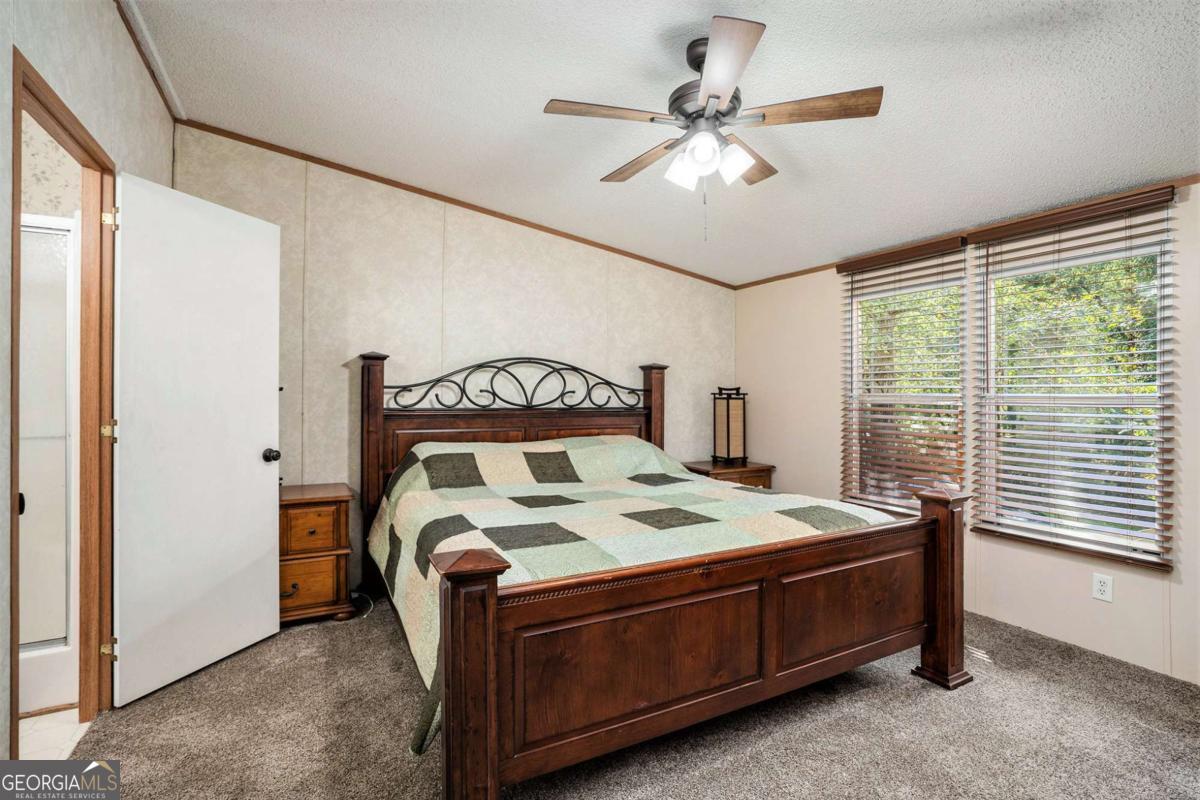 359 Norton Bridge Road Chatsworth, GA 30705 - Photo 5 of 28 a bed sitting in a room next to a window