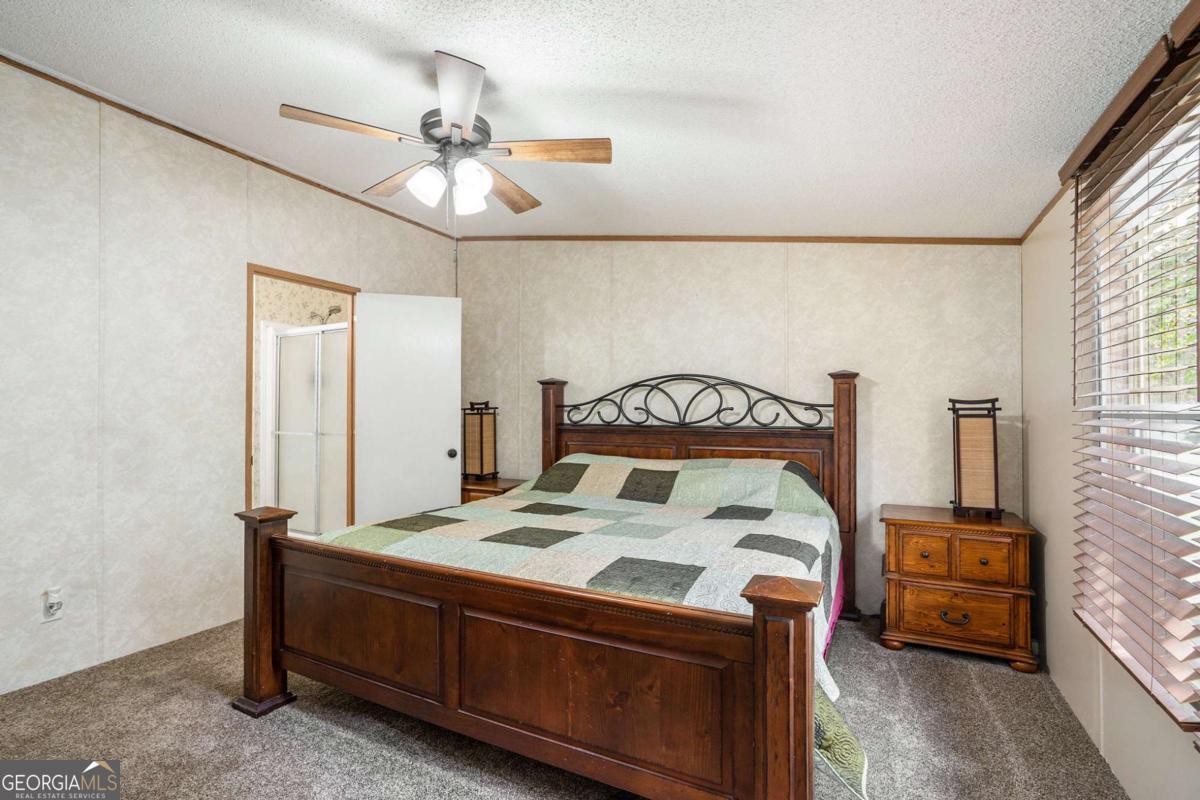 359 Norton Bridge Road Chatsworth, GA 30705 - Photo 6 of 28 a bedroom with a bed and a chandelier