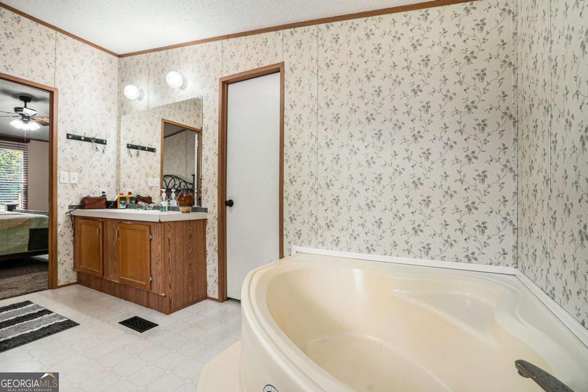 359 Norton Bridge Road Chatsworth, GA 30705 - Photo 10 of 28 a bathroom with a bathtub and a shower