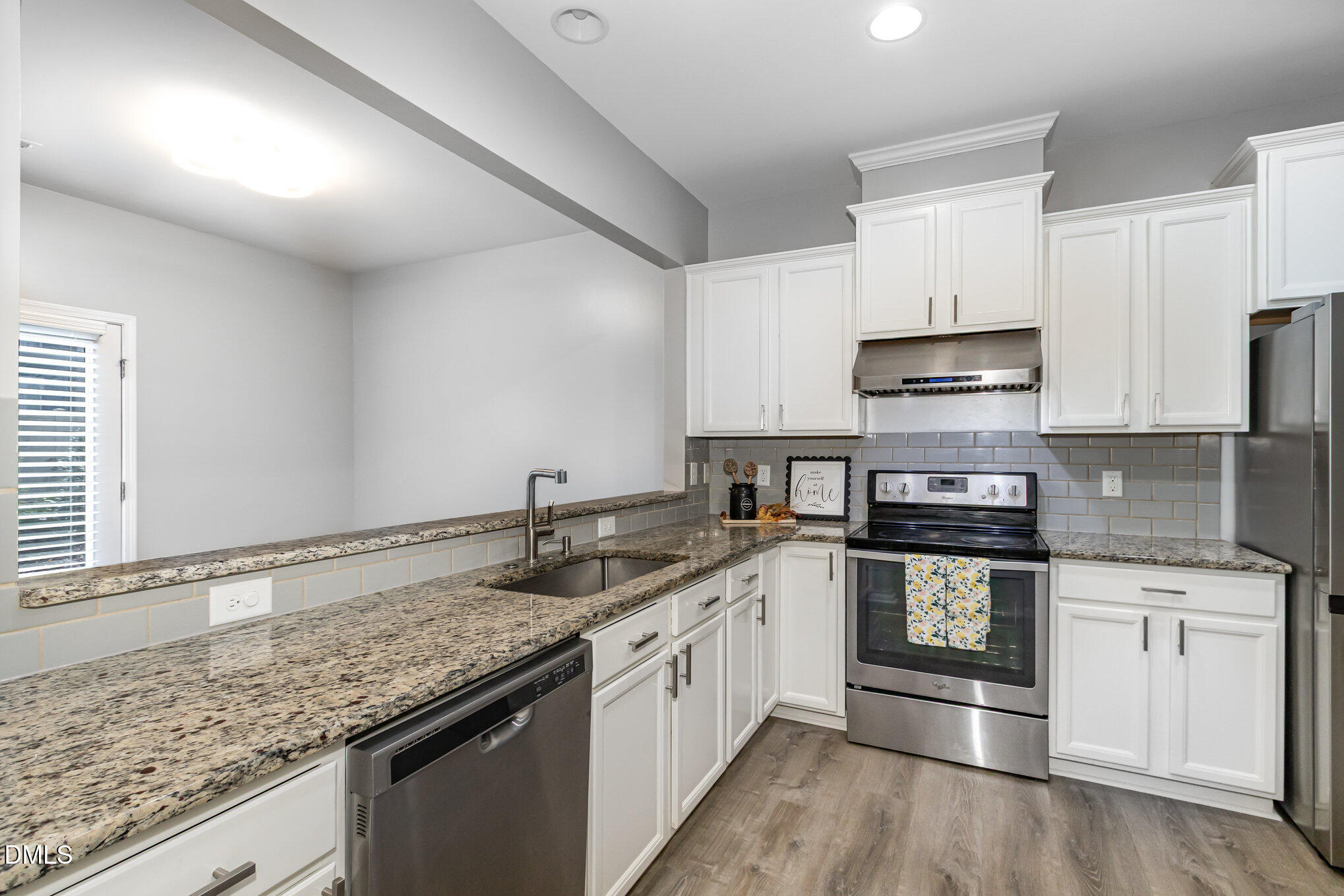 501 Brier Crossings Loop Durham, NC 27703 - Photo 11 of 31 a kitchen with granite countertop a sink stove and cabinets