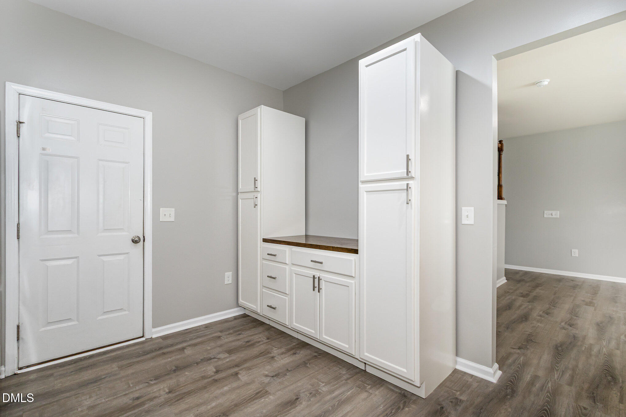 501 Brier Crossings Loop Durham, NC 27703 - Photo 12 of 31 an empty room with wooden floor and cabinet
