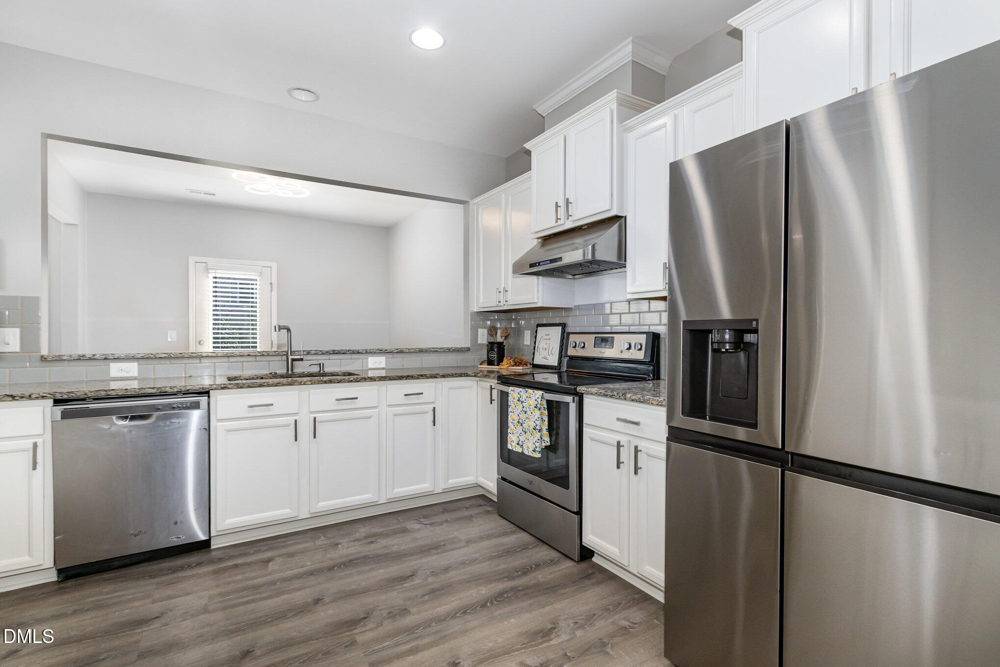 501 Brier Crossings Loop Durham, NC 27703 - Photo 13 of 31 a kitchen with white cabinets and stainless steel appliances