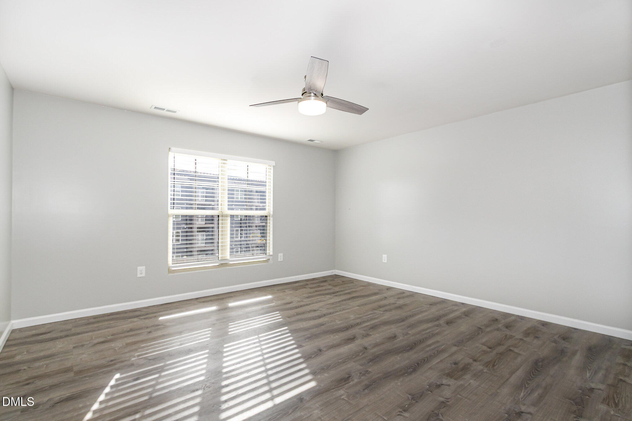 501 Brier Crossings Loop Durham, NC 27703 - Photo 16 of 31 a view of an empty room with wooden floor and a window