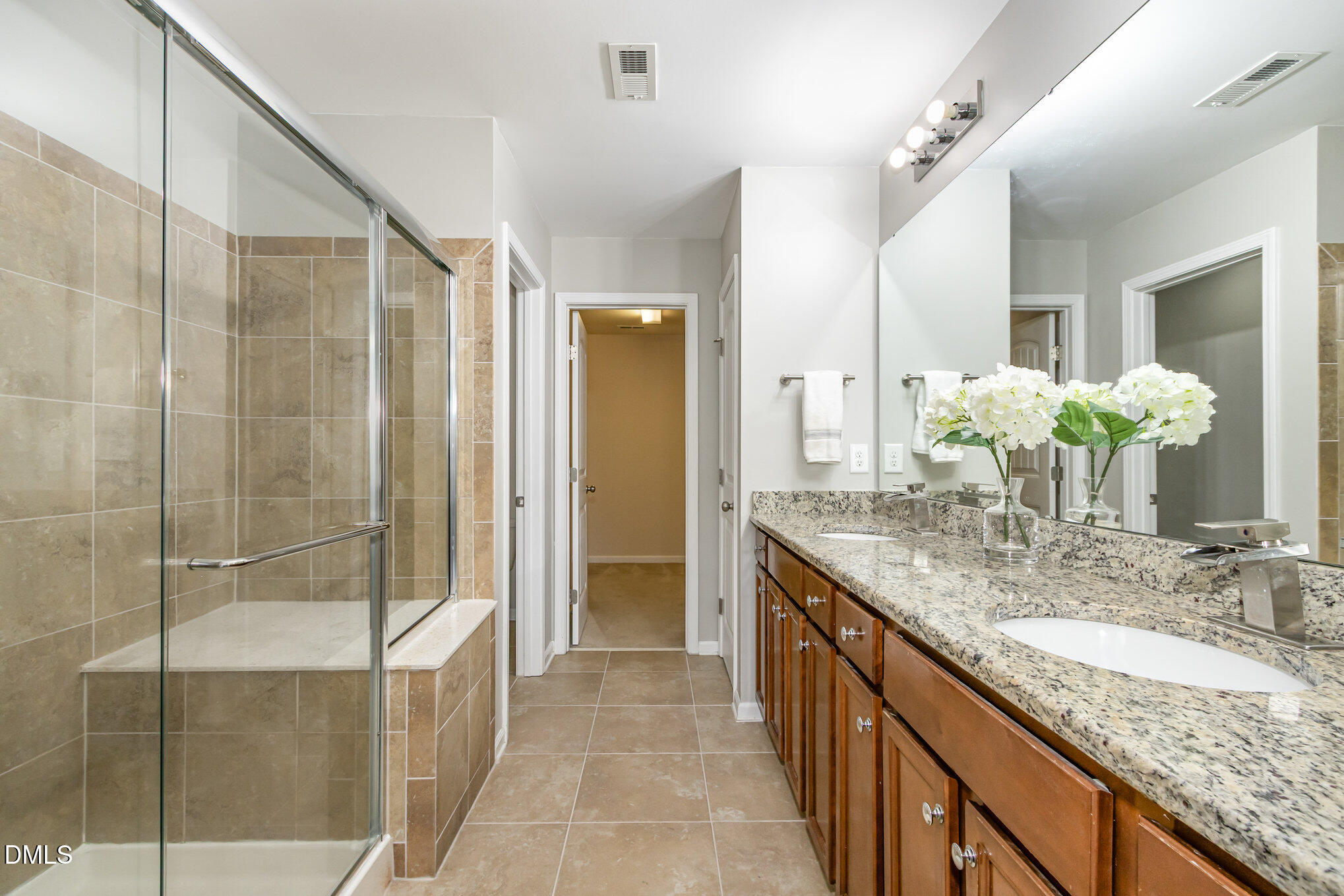501 Brier Crossings Loop Durham, NC 27703 - Photo 18 of 31 a bathroom with a granite countertop sink a mirror and a shower