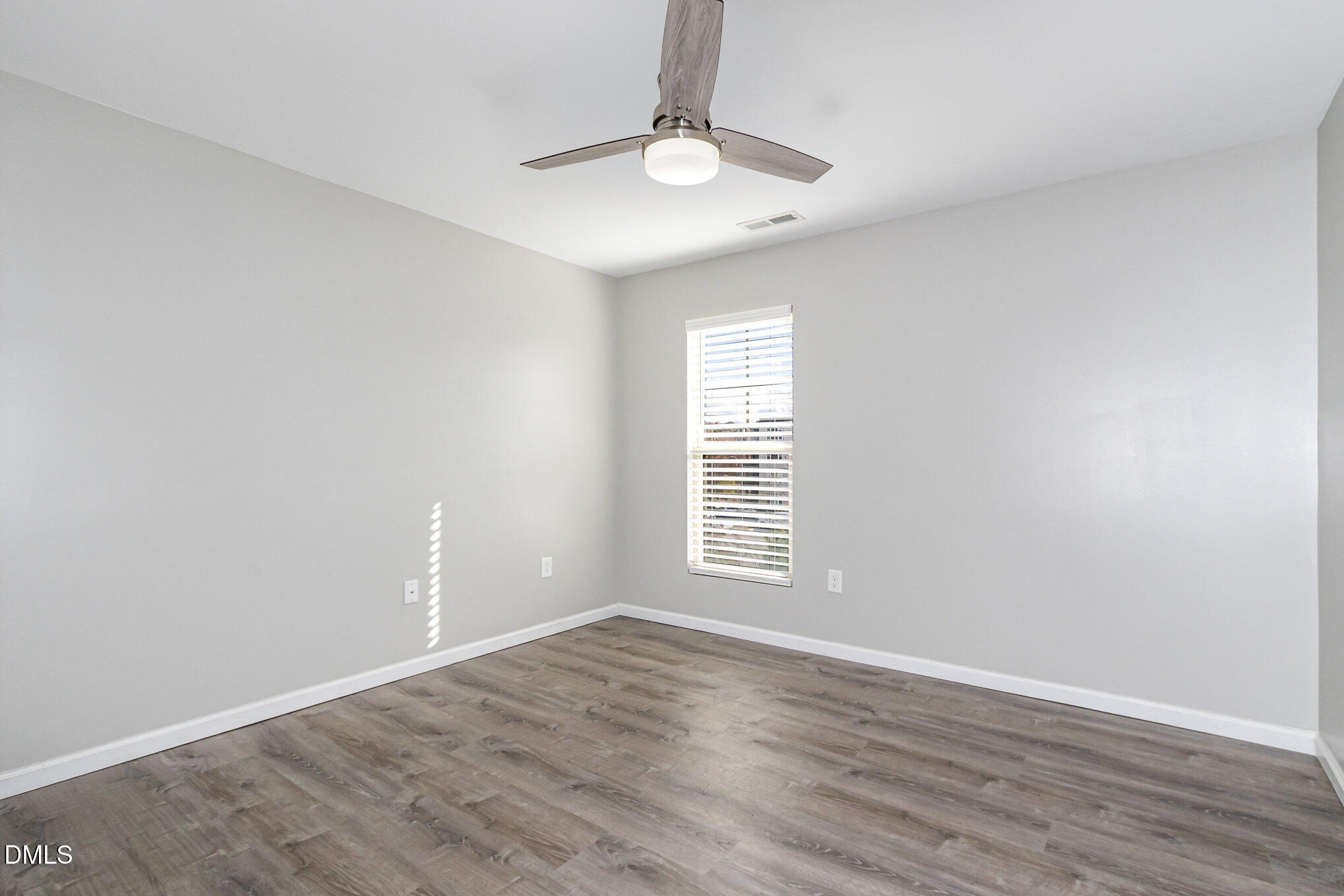501 Brier Crossings Loop Durham, NC 27703 - Photo 22 of 31 a view of an empty room with wooden floor and a window