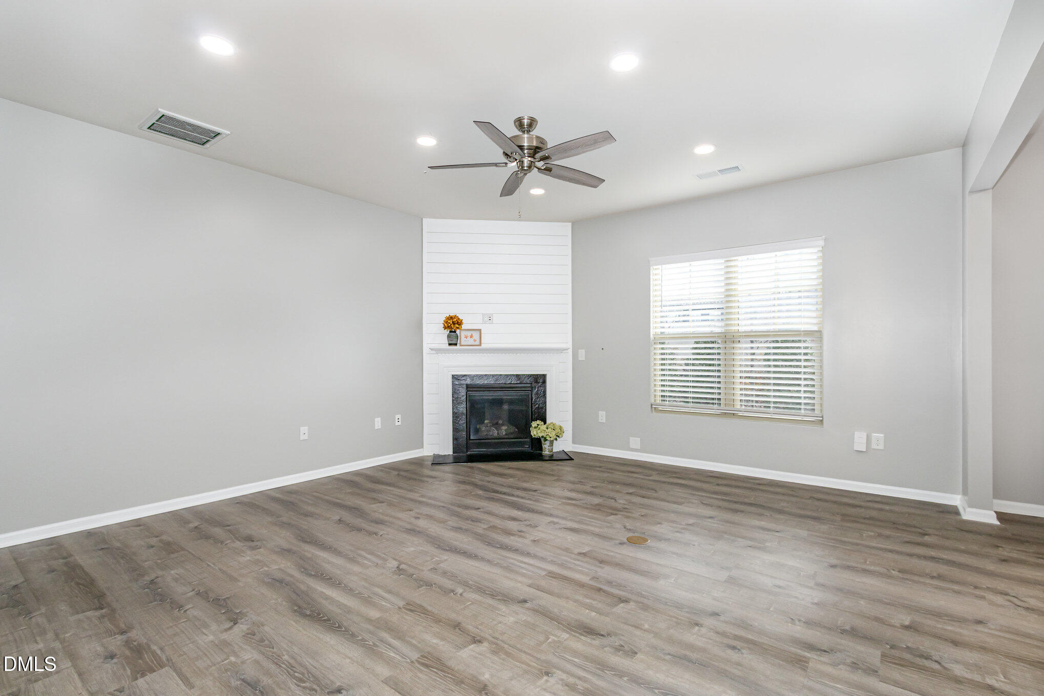501 Brier Crossings Loop Durham, NC 27703 - Photo 6 of 31 an empty room with chandelier fan and windows