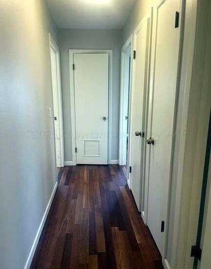 1401 Maple Avenue Panhandle, TX 79068 - Photo 11 of 42 a view of a hallway with wooden floor and closet area