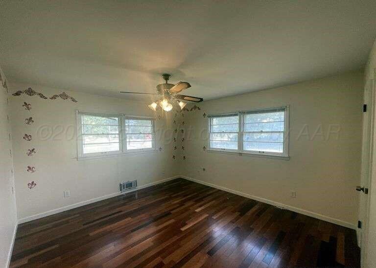1401 Maple Avenue Panhandle, TX 79068 - Photo 12 of 42 a view of empty room with wooden floor and fan