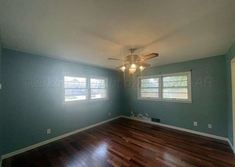 1401 Maple Avenue Panhandle, TX 79068 - Photo 14 of 42 a view of empty room with wooden floor and fan
