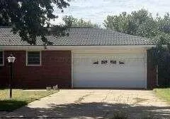 a large kitchen with a sink and cabinets