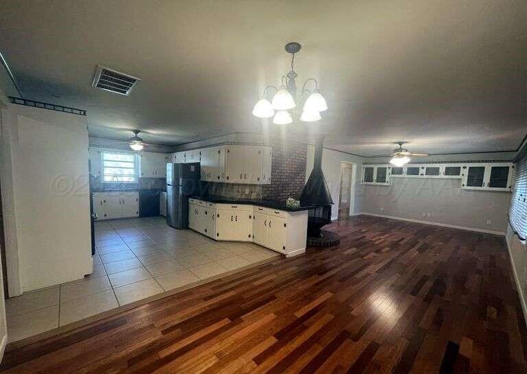 1401 Maple Avenue Panhandle, TX 79068 - Photo 26 of 42 a view of a living room and kitchen with furniture wooden floor