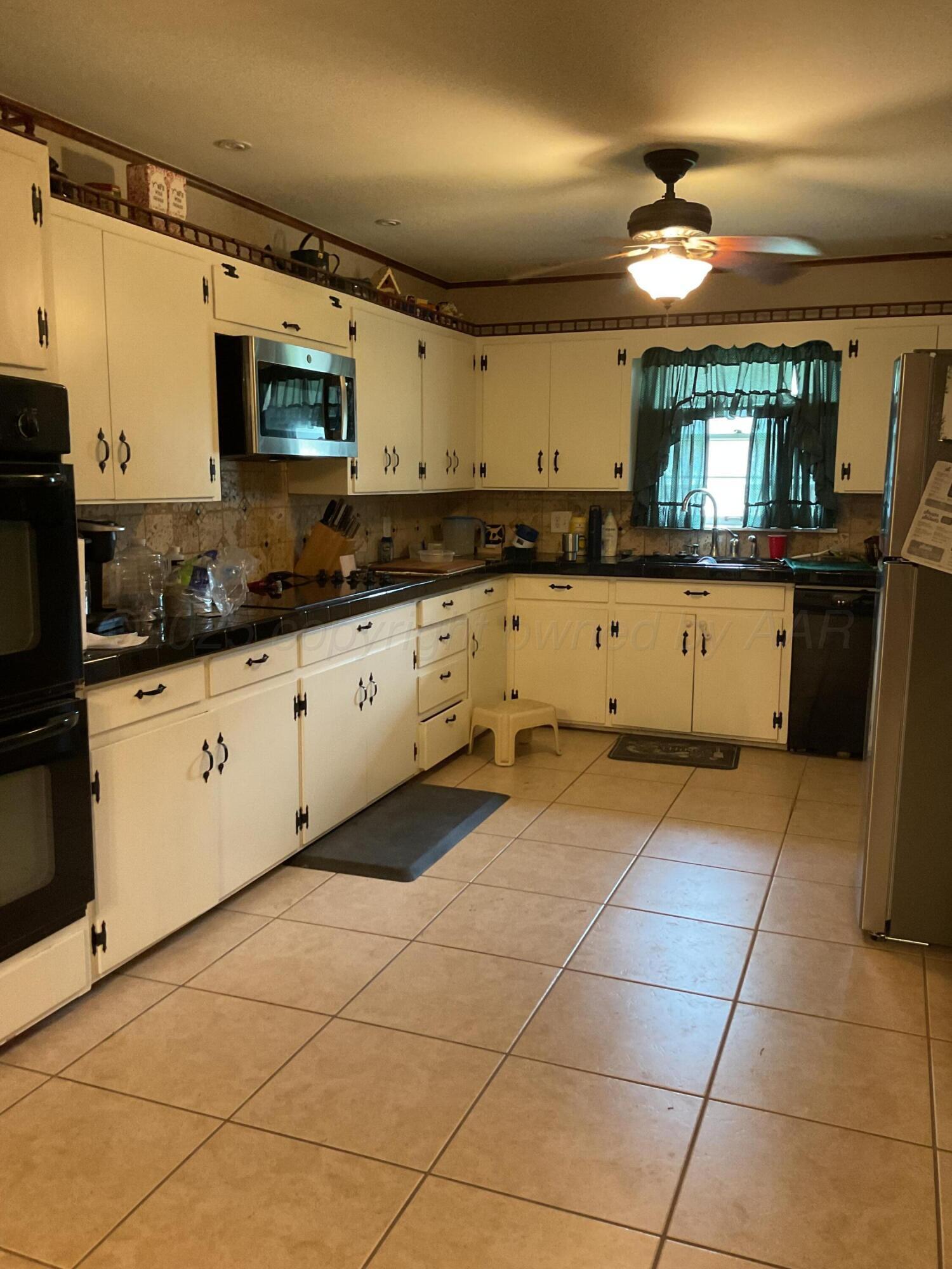 1401 Maple Avenue Panhandle, TX 79068 - Photo 3 of 42 a large kitchen with a sink and cabinets