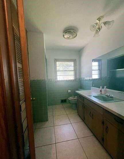 1401 Maple Avenue Panhandle, TX 79068 - Photo 31 of 42 a spacious bathroom with a granite countertop sink a mirror and a shower