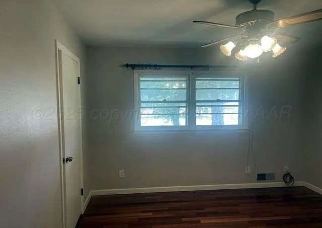 a view of a hallway with wooden floor and closet area