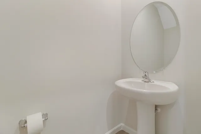 a bathroom with a sink a mirror and a toilet