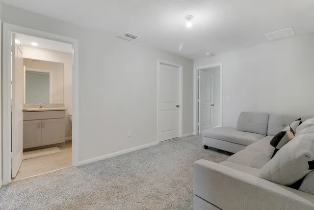 a living room with furniture and a walk in closet