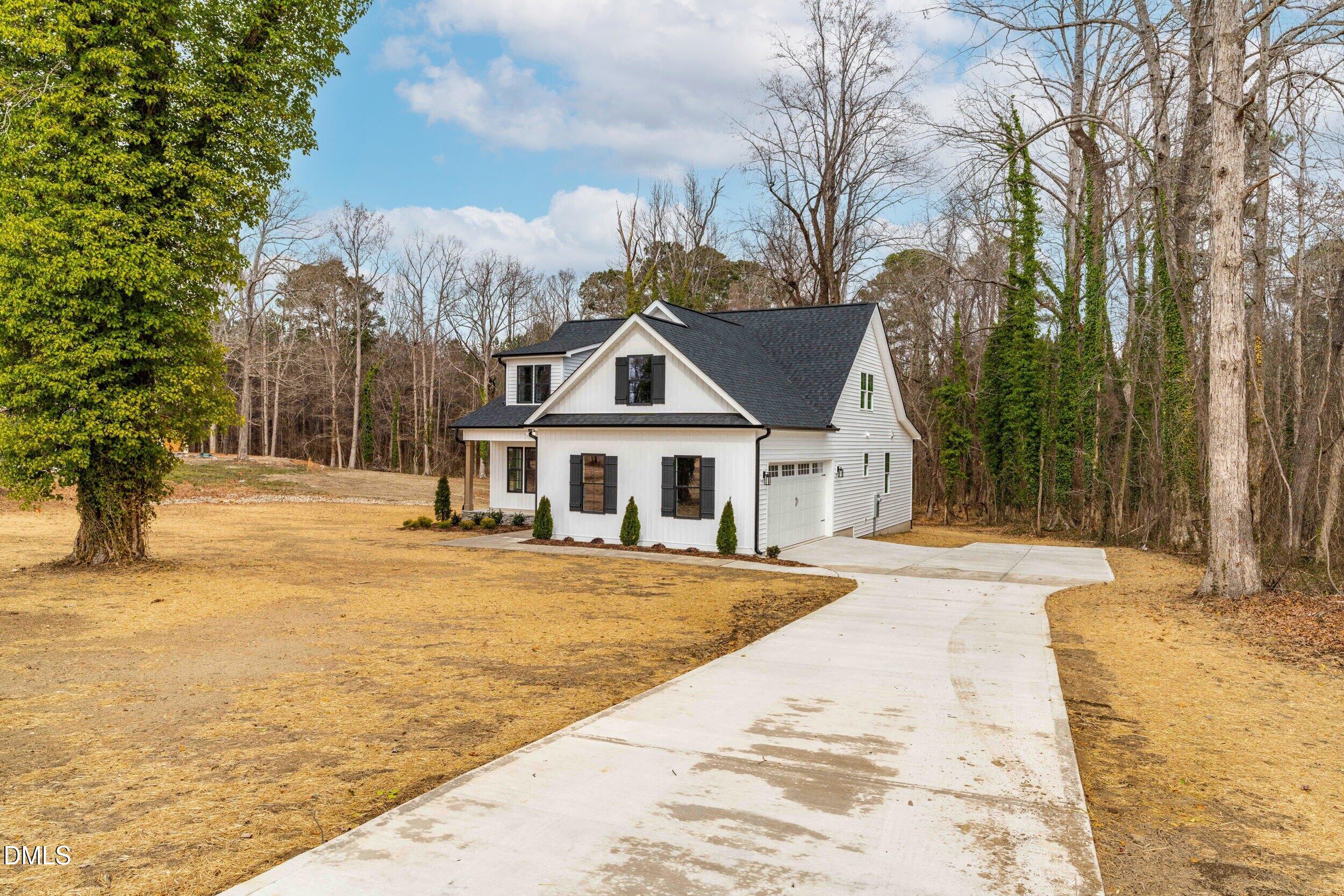 4029 Lake Wendell Road Wendell, NC 27591 - Photo 1 of 44 a front view of a house with a yard and garage