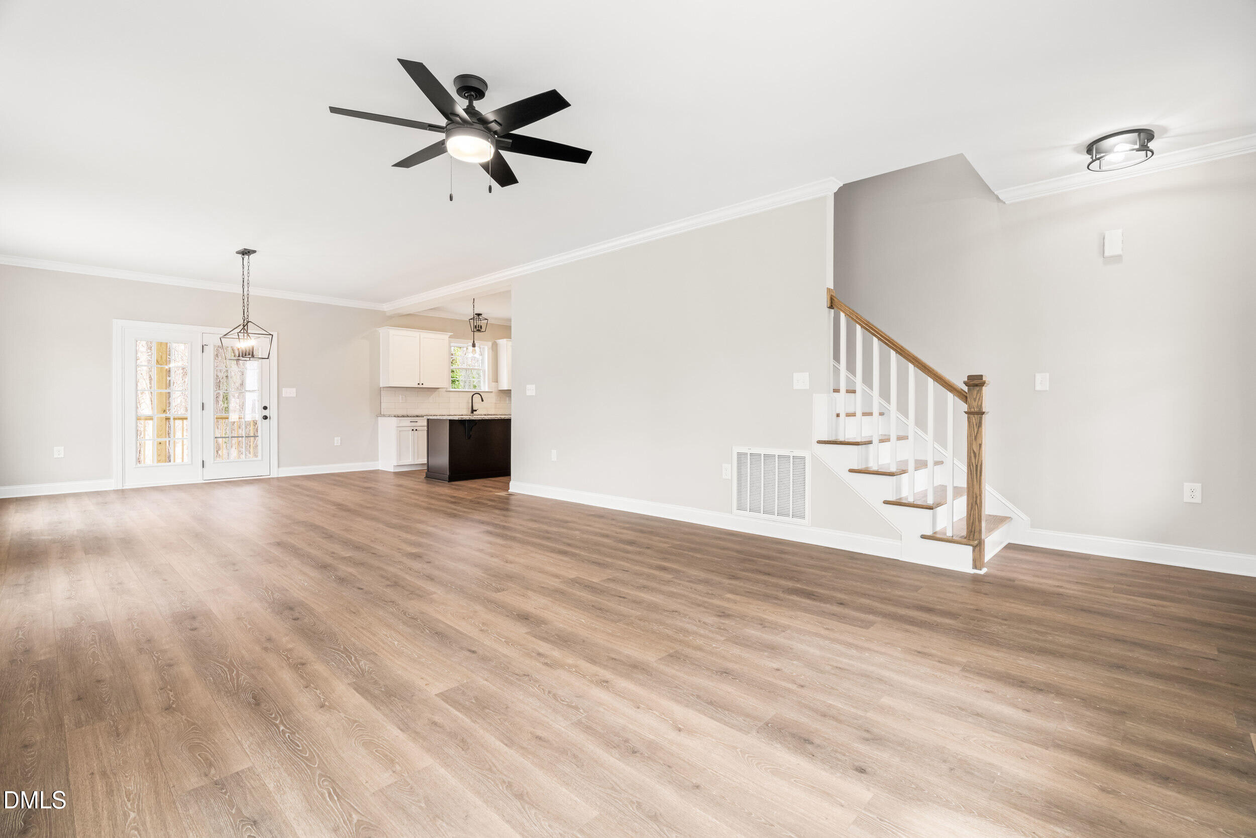 4029 Lake Wendell Road Wendell, NC 27591 - Photo 10 of 44 a view of an empty room with wooden floor and a ceiling fan