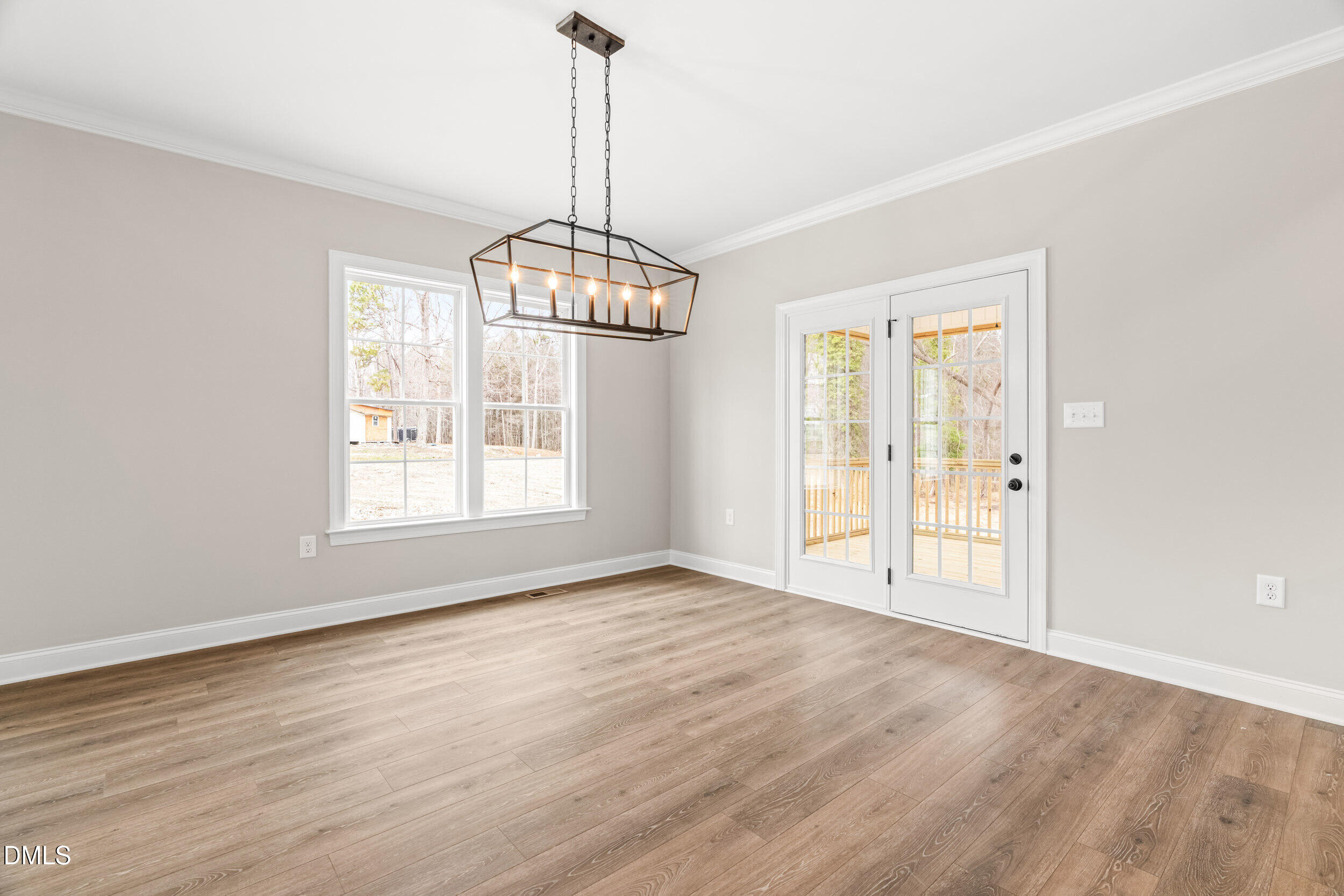 4029 Lake Wendell Road Wendell, NC 27591 - Photo 14 of 44 a view of an empty room with chandelier and glass door