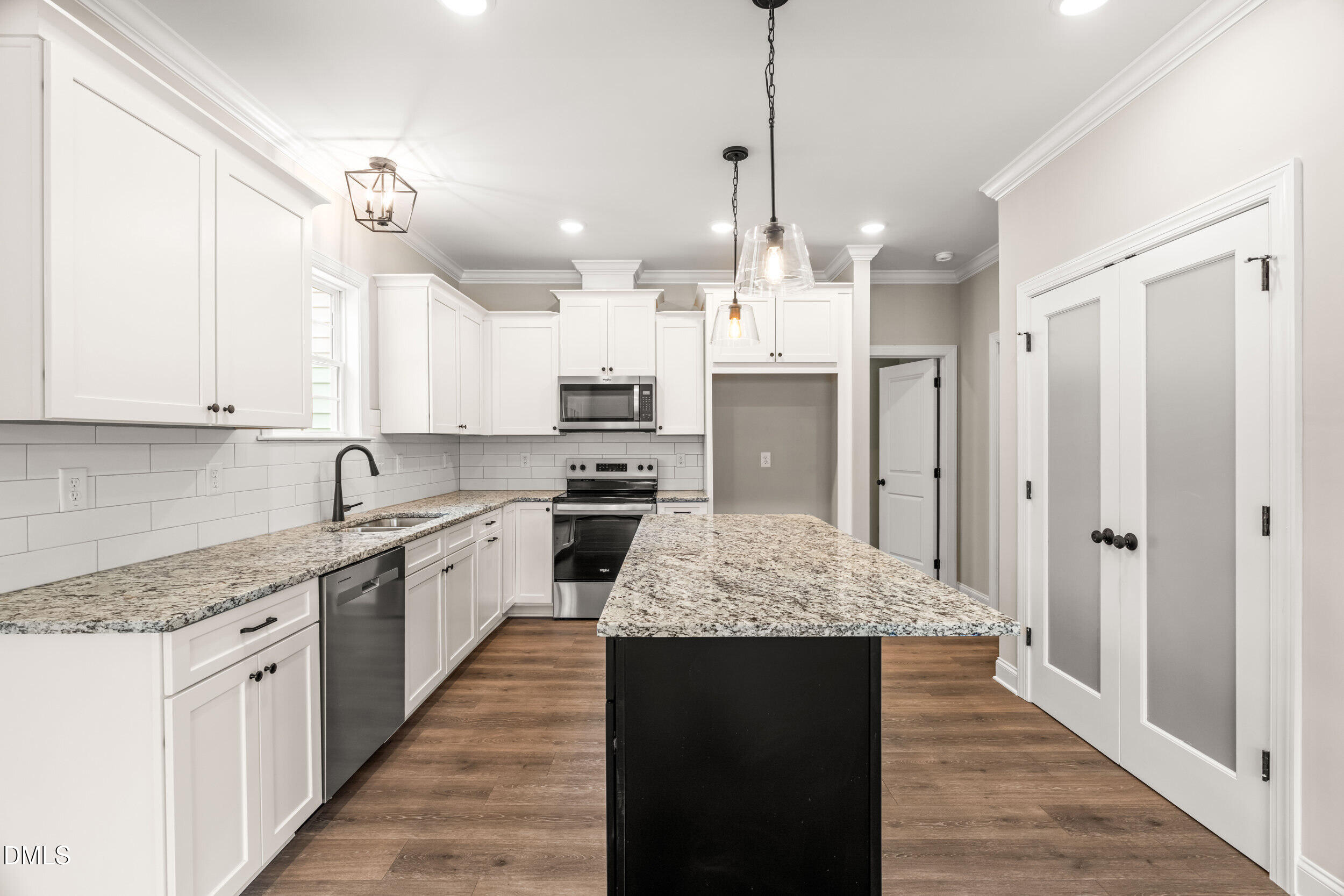 4029 Lake Wendell Road Wendell, NC 27591 - Photo 16 of 44 a large kitchen with stainless steel appliances kitchen island granite countertop a sink and refrigerator