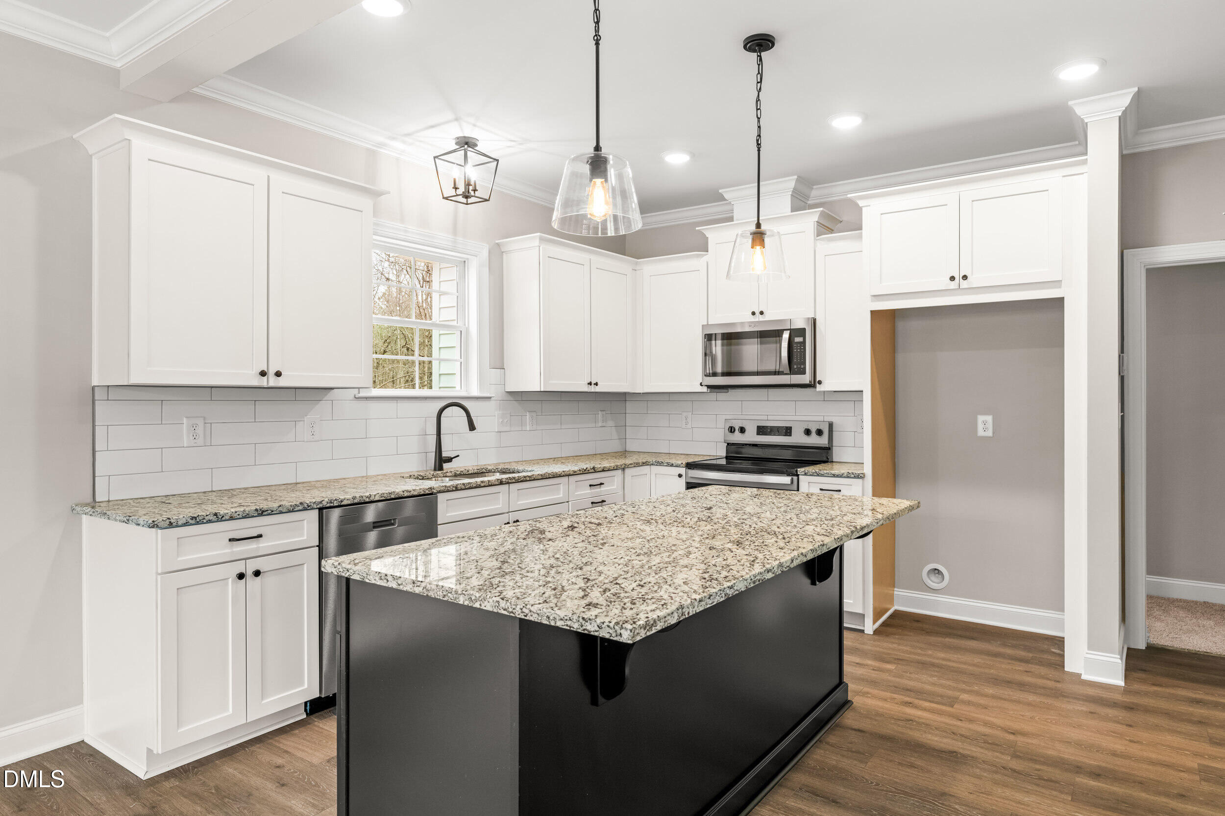 4029 Lake Wendell Road Wendell, NC 27591 - Photo 17 of 44 a kitchen that has a lot of cabinets and wooden floor