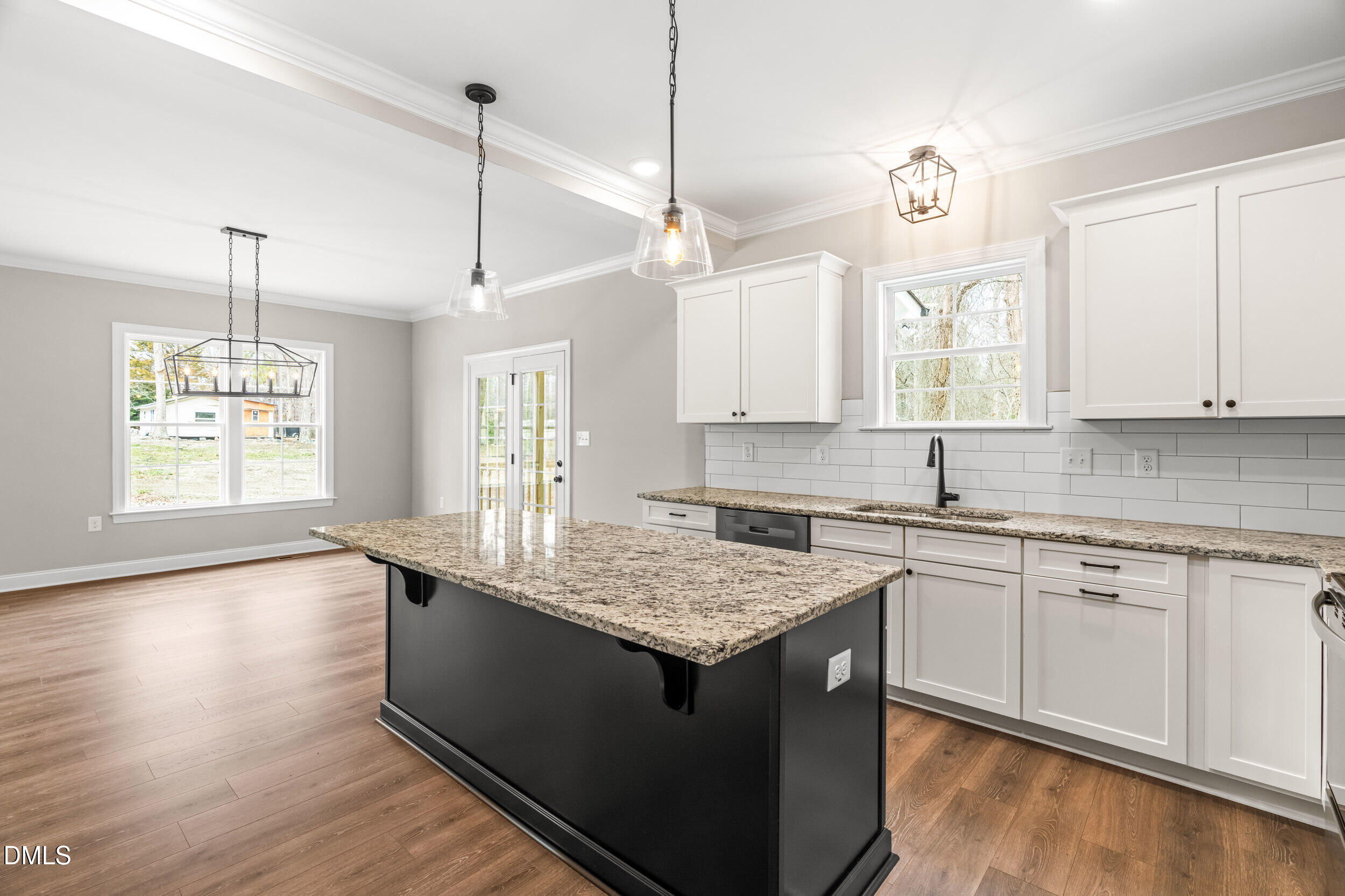 4029 Lake Wendell Road Wendell, NC 27591 - Photo 19 of 44 a kitchen with kitchen island granite countertop a sink cabinets and window