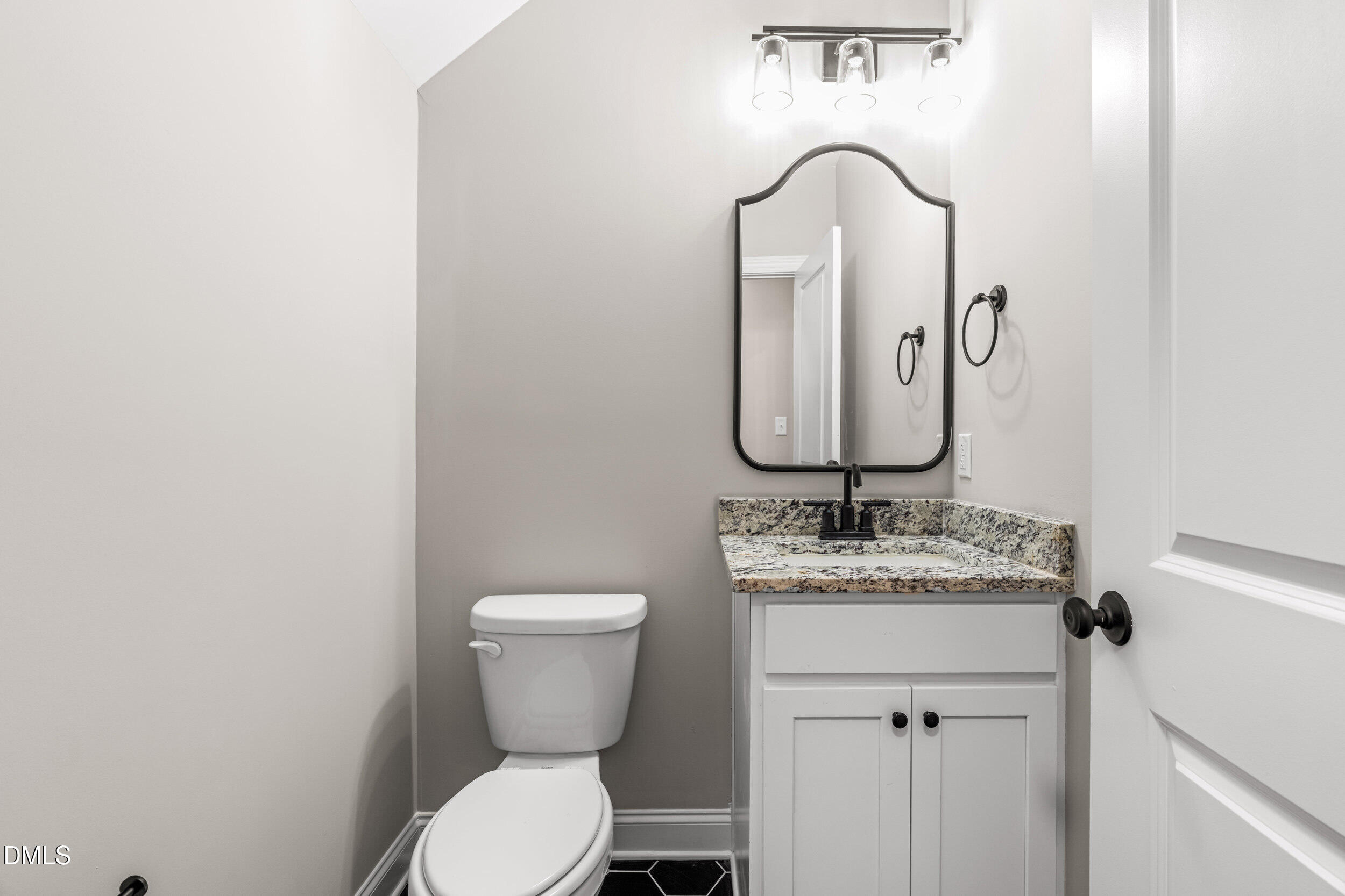 4029 Lake Wendell Road Wendell, NC 27591 - Photo 21 of 44 a bathroom with a granite countertop toilet sink and mirror