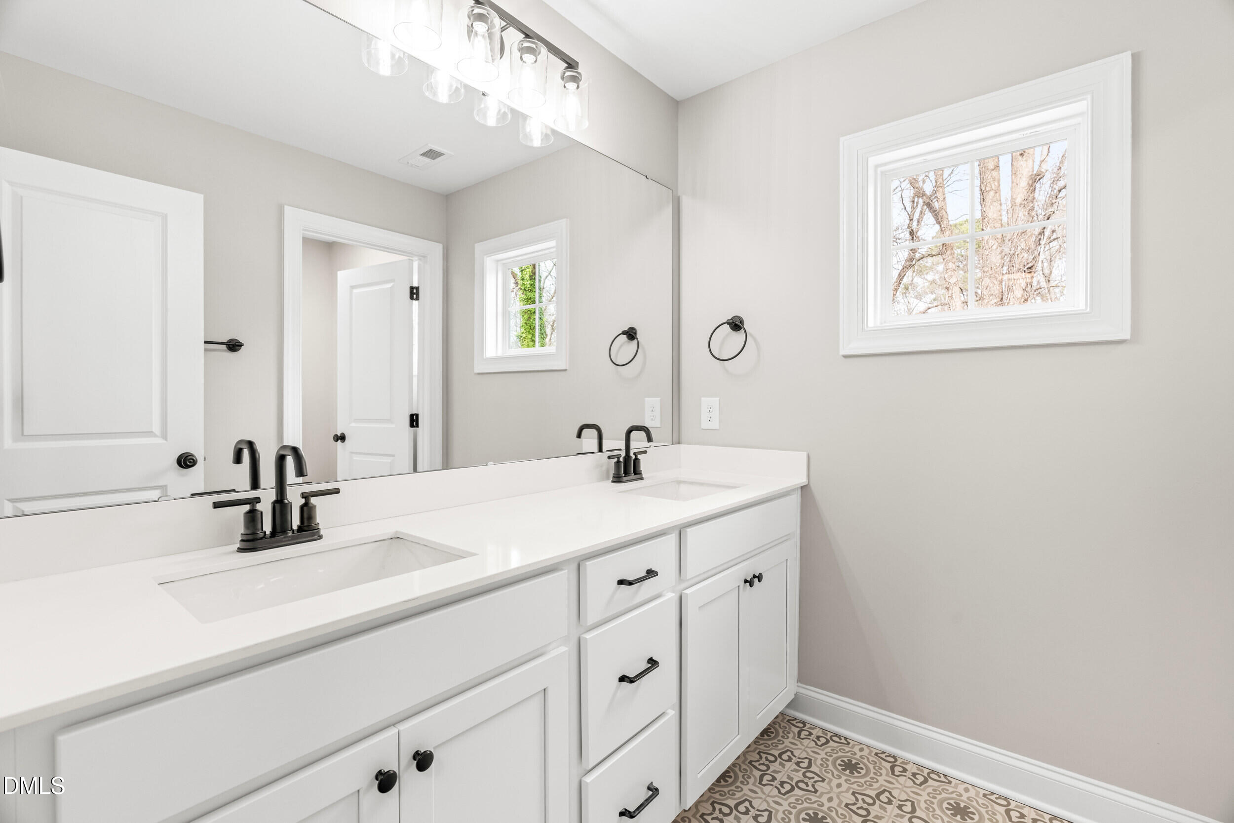 4029 Lake Wendell Road Wendell, NC 27591 - Photo 36 of 44 a bathroom with a double vanity sink and a mirror