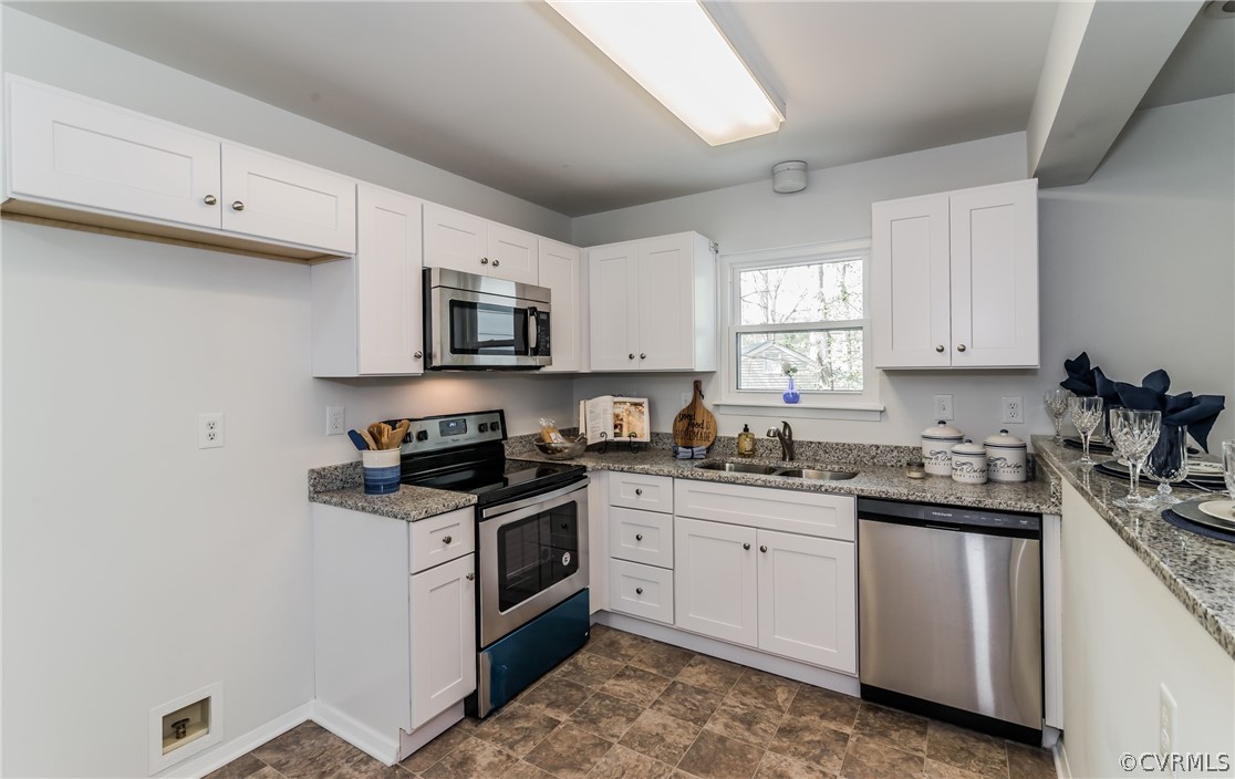 4403 Rabbit Foot Place North Chesterfield, VA 23236 - Photo 22 of 50 a kitchen with granite countertop a sink a stove and cabinets
