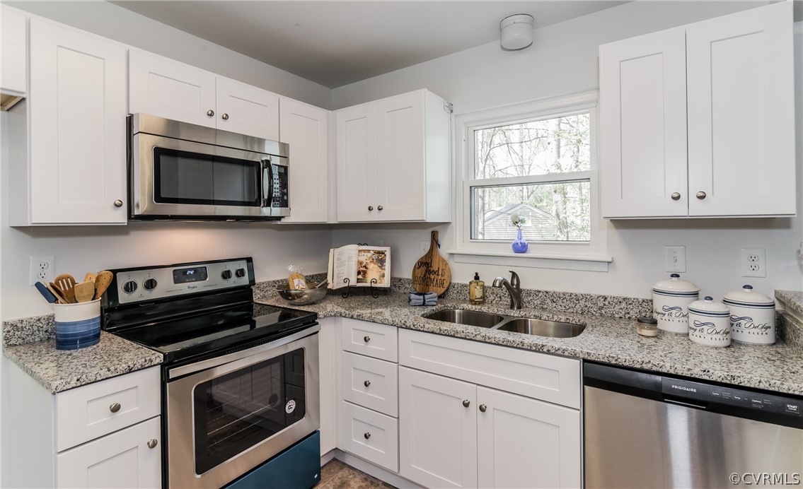 4403 Rabbit Foot Place North Chesterfield, VA 23236 - Photo 23 of 50 a kitchen with granite countertop white cabinets appliances a window and a sink