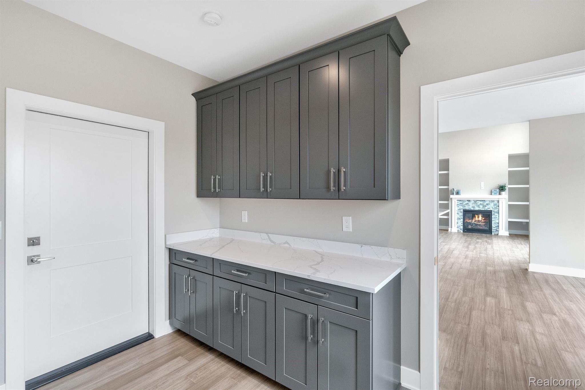 12240 Hibner Road Hartland, MI 48353 - Photo 31 of 37 Laundry room with cabinets for extra storage and quartz countertop