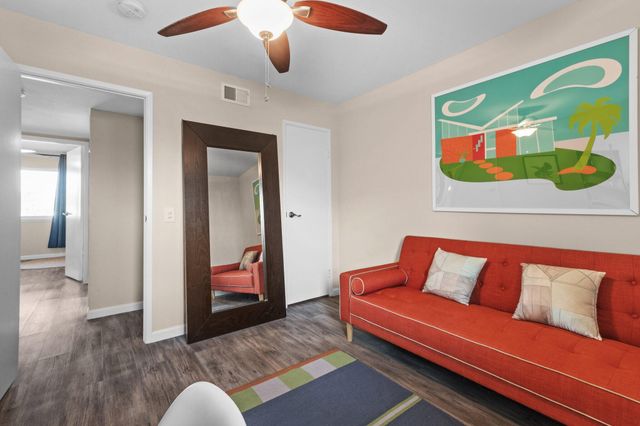 a living room with furniture and wooden floor