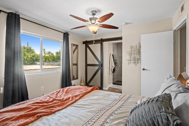 a bedroom with a bed and a large window