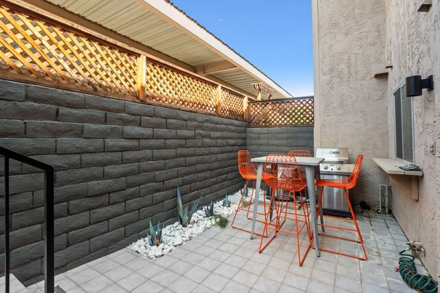 a patio with a table and chairs